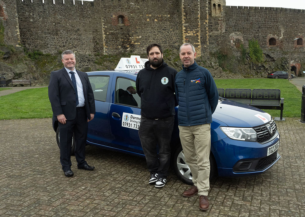 featured is Oran Dorman owner of Dorman’s Driving School, learner driver Matt and Sean Keenan, MEA Economic Development Officer.